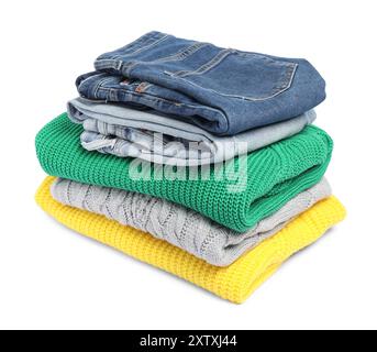 Stack of sweaters and jeans isolated on white Stock Photo