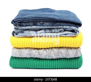 Stack of sweaters and jeans isolated on white Stock Photo