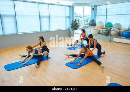Paired stretching exercises in a health group Stock Photo