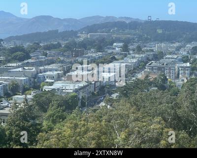 San Francisco, United States. 02nd July, 2024. Aerial view of residential rooftops and surrounding greenery with the Golden Gate Bridge in the background, Richmond District, San Francisco, California, July 2, 2024. (Photo by Smith Collection/Gado/Sipa USA) Credit: Sipa USA/Alamy Live News Stock Photo