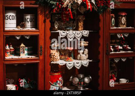 A jolly Santa Claus figurine stands cheerfully in a festive setting, surrounded by twinkling lights. Capturing the magic of the holiday season Stock Photo