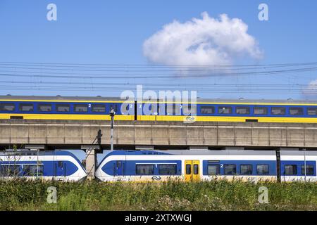 Trains of the Dutch railway, NS, Nederlandse Spoorwegen N.V., on a double-decker track, below local train Sprinter Light Train, above Intercity Direct Stock Photo