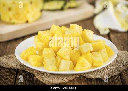 Fresh made Pineapple (sliced) on a vintage background as detailed close-up shot Stock Photo