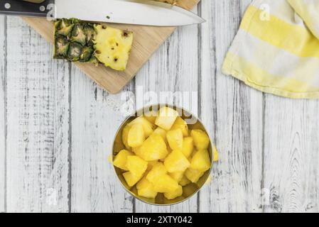 Fresh made Pineapple (sliced) on a vintage background as detailed close-up shot Stock Photo