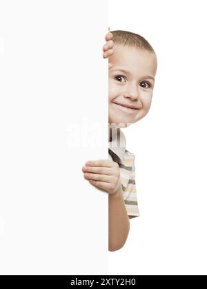 Little smiling child boy holding blank white sign or placard Stock Photo