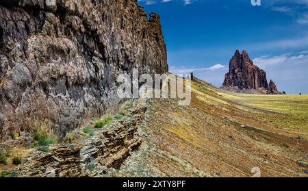 Volcanic Plug, Shiprock, NM Shiprock is composed of fractured volcanic breccia and black dikes of igneous rock called minette. Stock Photo