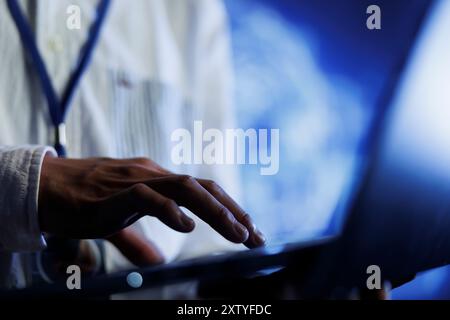 Certified engineer writes code on laptop to visualize artificial intelligence neural networks using augmented reality technology, close up. Data center expert runs AI script for information processing Stock Photo