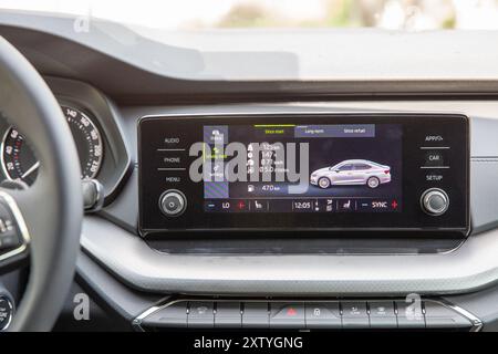 Kyiv, Ukraine - April 14, 2024: Czech new model Skoda Octavia A8 infotainment system showing navigation, fuel efficiency, and other features closeup. Stock Photo