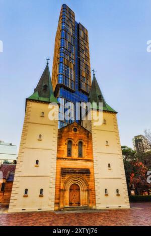 Spectacular historic heritage St John's cathedral in the city of Parramatta next to modern high-rise apartment office building. Stock Photo