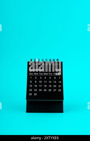 September 2024 Black spiral desktop calendar on red color textile Stock ...