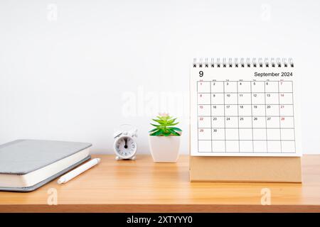 September 2024, Monthly desk calendar for 2024 year on wooden table with diary. Stock Photo