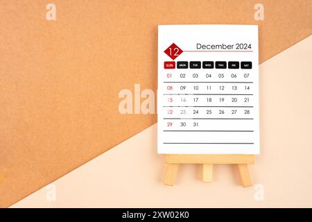 2024 December calendar page on brown paper background. Stock Photo