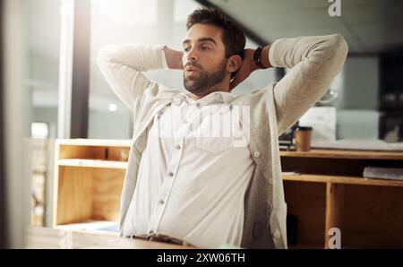 Man, stretching and thinking at desk for business, break and waiting for software update in office. Architect, recline and whistle at computer for Stock Photo