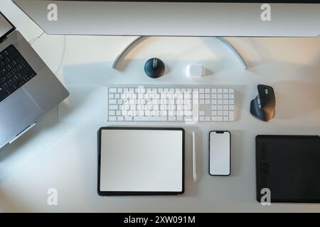 Smart devices blank screen mockup. Home studio office desktop. Table from above. Top view. Screen mockup. Graphic tablet, mobile phone, display monito Stock Photo