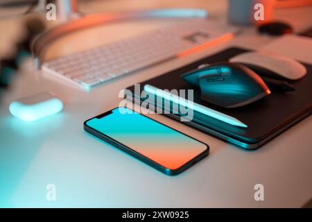 Smart phone and keyboard on home office studio table. Graphic designer tools. Stock Photo