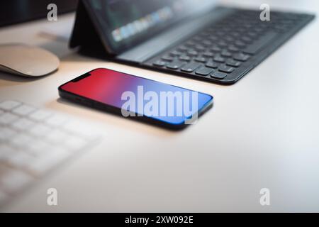 Smart phone and keyboard on home office studio table. Stock Photo