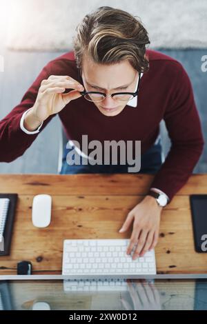 Research, reading and business man on computer for email survey or concentration in top view at startup. Screen, keyboard or worker in office with Stock Photo
