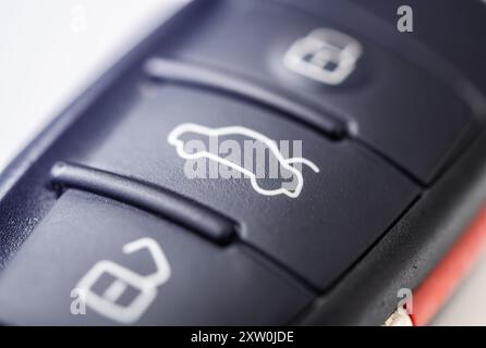 A detailed view of a sleek car key remote, featuring buttons for locking and unlocking doors. The design showcases modern automotive technology and co Stock Photo