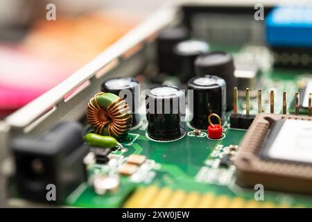 Detailed view of a modern electronic circuit board featuring capacitors, an inductor, and various components integrated for advanced technology produc Stock Photo