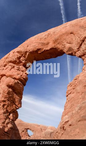 Turret Arch frames North Window Arch. Unrecognizable people on North Window Arch. Arches National Park. Utah. Stock Photo