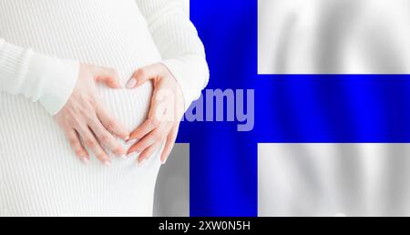 Demographics, pregnancy and love baby in Finland concept. Pregnant woman making heart against her stomach on Finnish flag background. Stock Photo