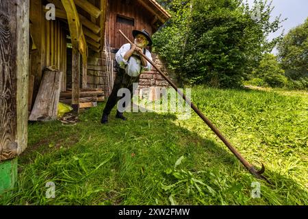 Raftsman Martin Spreng shows the raft hook, a long wooden pole fitted with an iron hook and spike. The tool was indispensable for almost every task on a raft. Spreng, chairman of the German Rafting Association, demonstrates historical Black Forest rafting at the Monhardter Wasserstube near Altensteig, Baden-Württemberg, Germany. Rafters shipped timber here on the Nagold river until 1911. Rafting has been recognised as UNESCO intangible cultural heritage since 2022. Stock Photo