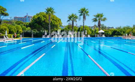 Antalya-Turkey: September 11, 2022: Outdoor olympic swimming pool and greenery in a 5 star luxury hotel in summer. Stock Photo