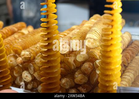 Tornado potato also called twist potato or potato twister on a stick at a street food stall Stock Photo