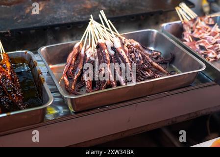 Squid tentacles on sticks known as ikayaki in Japan Stock Photo