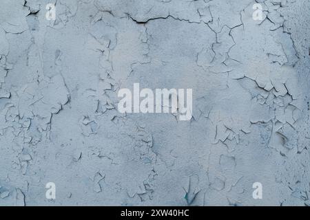 The wall is covered with cracked paint. Backgrounds and textures. Stock Photo