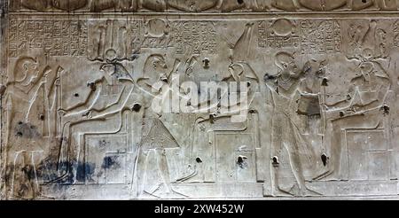 Wall relief in the Chapel sanctuary of Horus shows King Seti offering incense to the God Horus in various forms in the Temple of Seti built in 13th century BC by the Pharoah Seti I near Abydos,Egypt Stock Photo