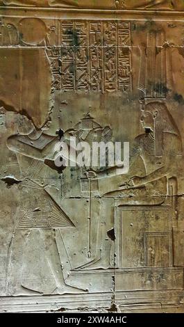 Wall relief in the Chapel of Isis shows King Seti offering  a necklace to Goddess Isis in the Temple of Seti built in 13th century BC by the Pharoah Seti I near Abydos,Egypt Stock Photo