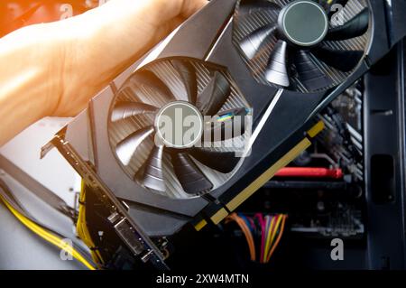 Technician repairing computer Change the graphics card in the computer. Stock Photo