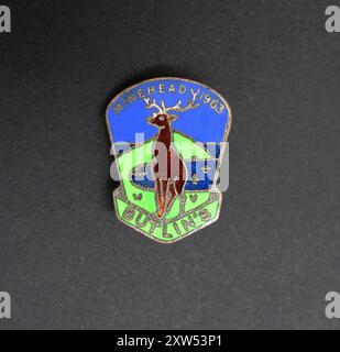 A vintage enamel lapel pin badge made in 1963 as a souvenir for visitors of the Butlin’s Holiday Camp in Minehead, Somerset, England. The badge is decorated with the image of a deer. This camp opened to the public in May 1962 and is still in operation. Stock Photo