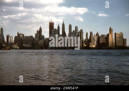 New York, USA. September 1959 – A view of the Lower Manhattan skyline taken from the Hudson River, New York. Piers 10, 11 & 13 and Liberty Street Ferry Terminal are visible in the foreground. The buildings behind include the Singer Building, Cities Service Building, the City Bank–Farmers Trust Building, Bank of Manhattan Trust Building, and the Downtown Athletic Club. The photograph also shows the One Chase Manhattan Plaza building under construction. Stock Photo