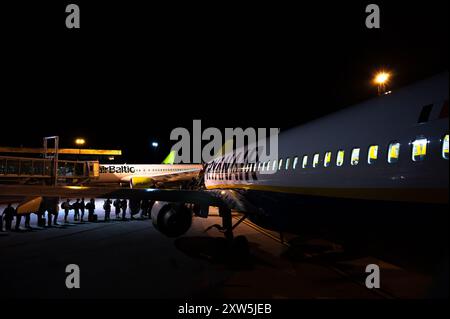 Passengers boarding a Ryanair flight at Tallinn Airport at night, Estonia Stock Photo