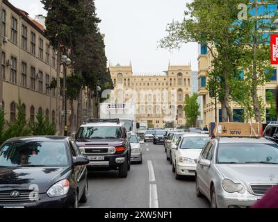 Baku, Azerbaijan - May 3, 2019: Busy traffic in Baku, Azerbaijan, featuring a mix of cars and buses navigating through a bustling urban environment, reflecting the dynamic energy of the city with modern buildings and street activity Stock Photo