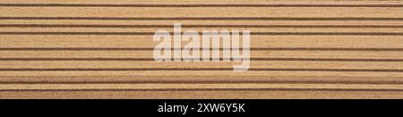 Rich golden and caramel tones dance across this Santos Rosewood veneer, creating a luxurious linear landscape Stock Photo