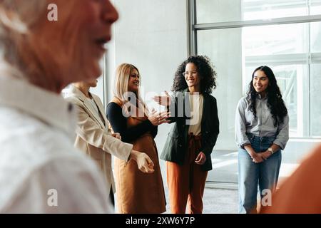 Diverse group of professionals interacting and sharing ideas at a business workshop during a conference. Stock Photo