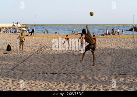 People Playing Volleyball on Platja De La Fragata in Sitges, Spain Stock Photo