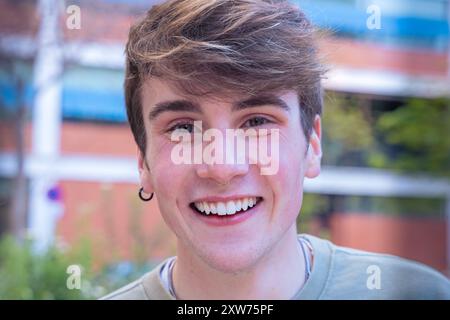 Portrait young caucasian man smiling confident standing at street. Stock Photo