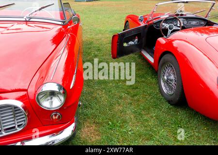 Two red cars, the veterans Czechoslovak Škoda Felicia and the British MG MGA 1600 Roadster Convertible Two vintage cars Retro nostalgic style Stock Photo