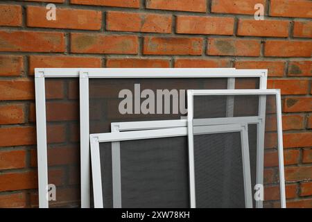 Window Screen Set Designs Set of window screens near brick wall Stock Photo - Alamy