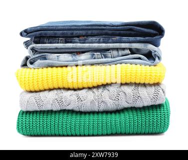 Stack of sweaters and jeans isolated on white Stock Photo