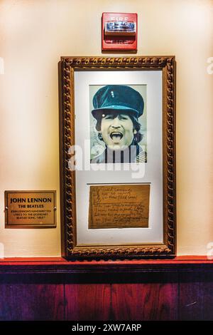 Framed photograph of John Lennon from The Beatles with his handwritten note displayed on the wall at the Hard Rock Cafe museum in Manhattan. New York. Stock Photo