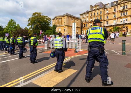 Bournemouth, Dorset, UK. 18th August 2024. Anti-immigration protestors hold 'Take Back Our Country' peaceful protest in Bournemouth. Counter-protestors organised their own protest at the same time in response to the far-right protest. Extra police resources from across the country have been brought in with police being given extra powers in light of violence and damage seen across the UK for similar protests and riots. Credit: Carolyn Jenkins/Alamy Live News Stock Photo