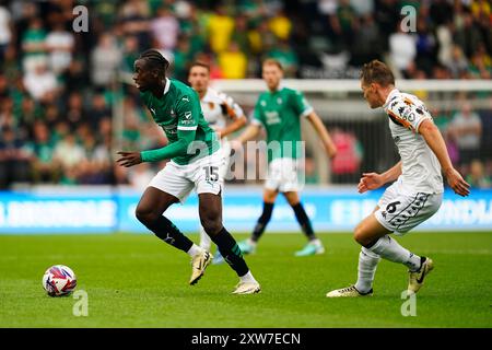 Plymouth Argyle's Mustapha Bundu and Hull City's Sean McLoughlin in action during the Sky Bet Championship match at Home Park, Plymouth. Picture date: Saturday August 17, 2024. Stock Photo