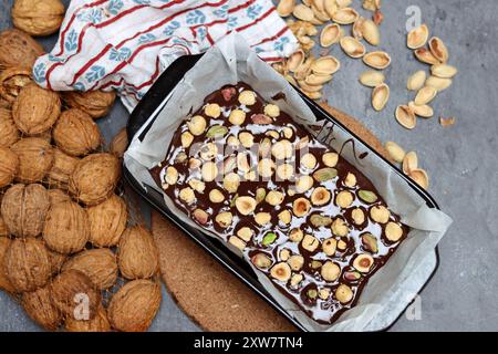 Chocolate cake with pistachios and nuts in a baking sheet Stock Photo