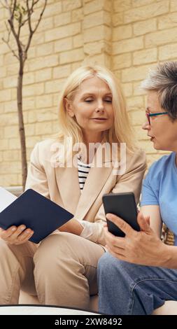 A Heartwarming and Engaging Conversation Between Two Women in a Modern and Cozy Setting Stock Photo