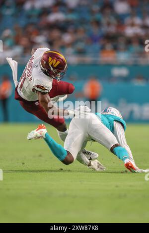 Miami Gardens, FL USA;  Washington Commanders running back Jeremy McNichols (31) runs with the ball and tackled by Miami Dolphins cornerback Cam Smith Stock Photo